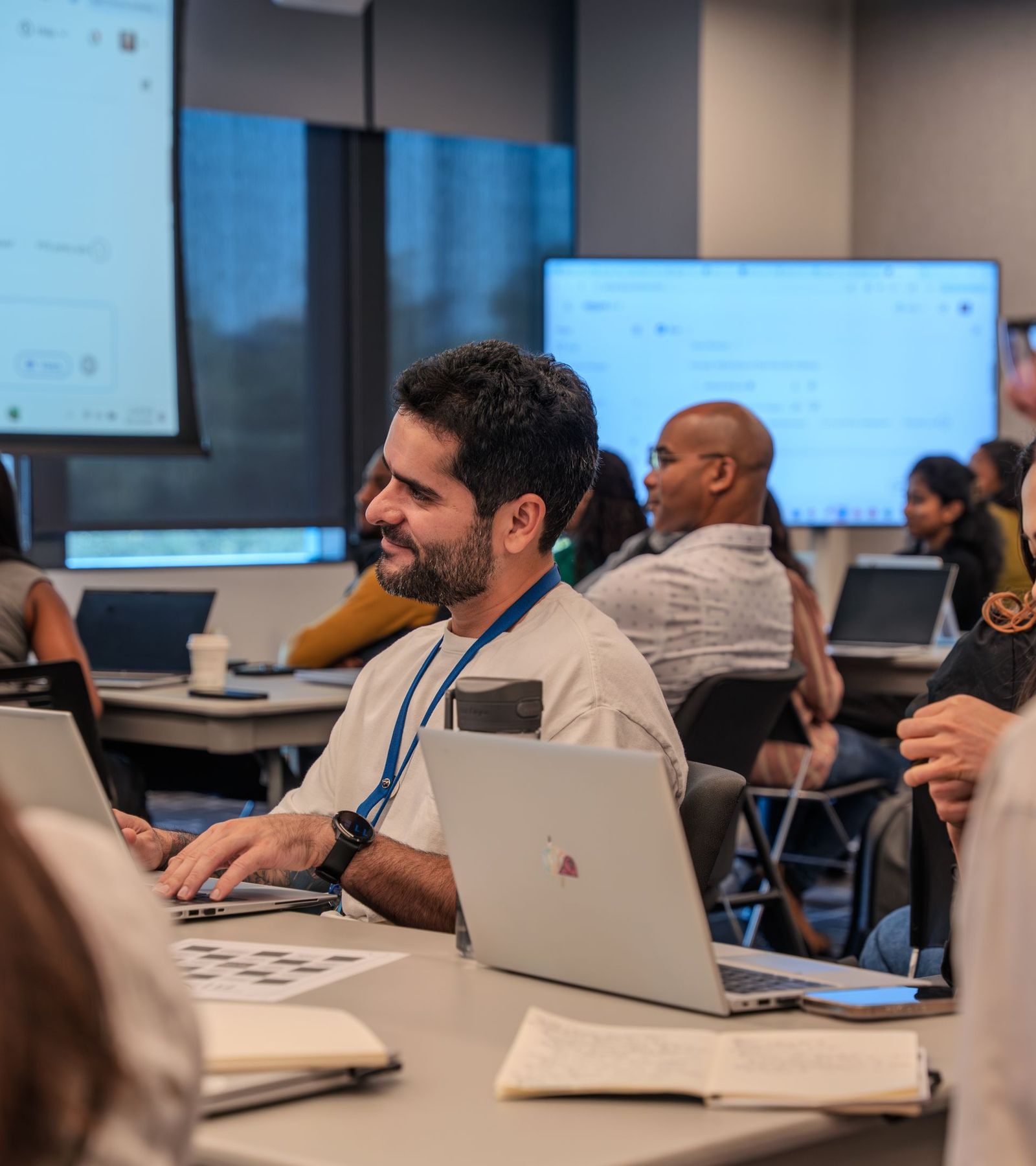 Adults working on laptops during a training workshop